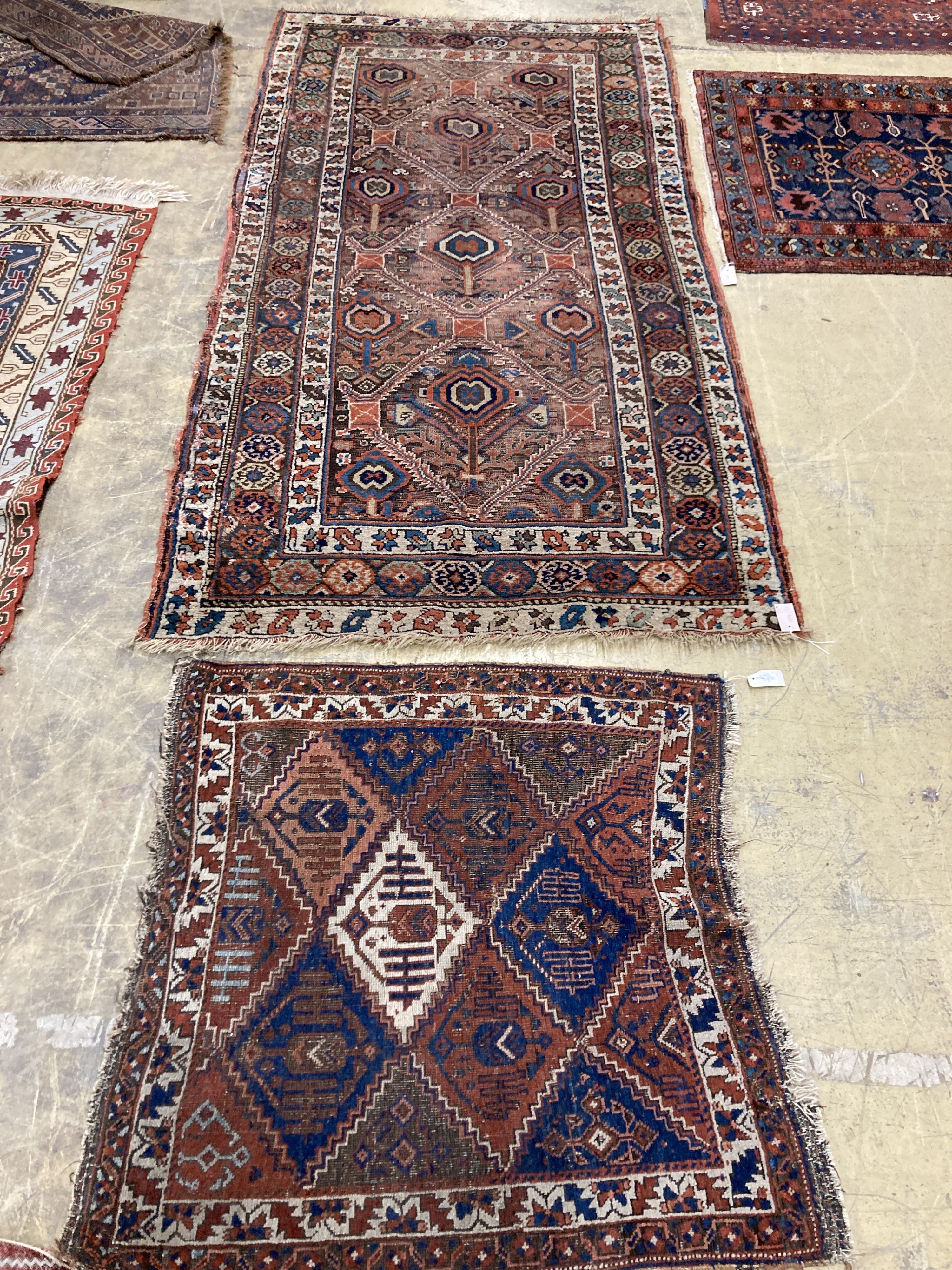 An antique Caucasian red ground rug, 250 x 125 cm and a smaller Shiraz rug.